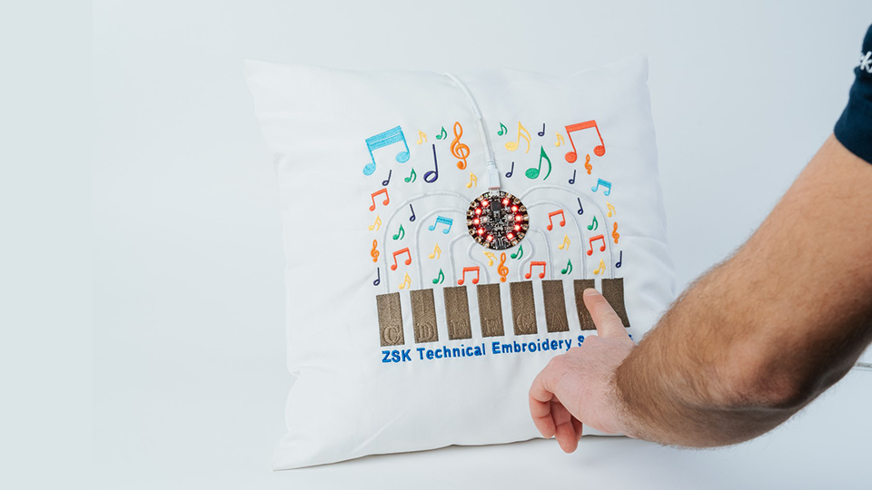 A functioning piano embroidered onto a pillow