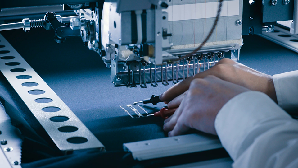 3E Smart Solutions hands-on smart textiles workshop - resistance measurement of embroidered conductive trace at the embroidery machine