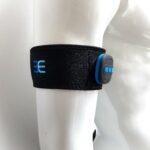 3E EMS arm cuff prototype worn on athlete’s arm with moss-embroidered electrodes and controlling device for muscle stimulation