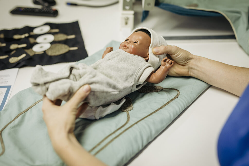 NeoSmartNest hammock for premature infants with integrated moss-embroidered textile electrodes for ECG monitoring