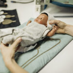 NeoSmartNest hammock for premature infants with integrated moss-embroidered textile electrodes for ECG monitoring