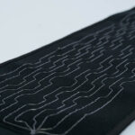 Close-up of embroidered heating wire zigzag pattern in textile lining